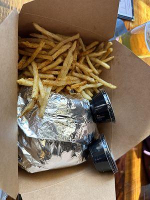 Delicious smash burger : double cheeseburger with fries and a side of mayo and ketchup.