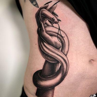 Custom Snake and hand tattoo done by Tattoo Artist Jerry