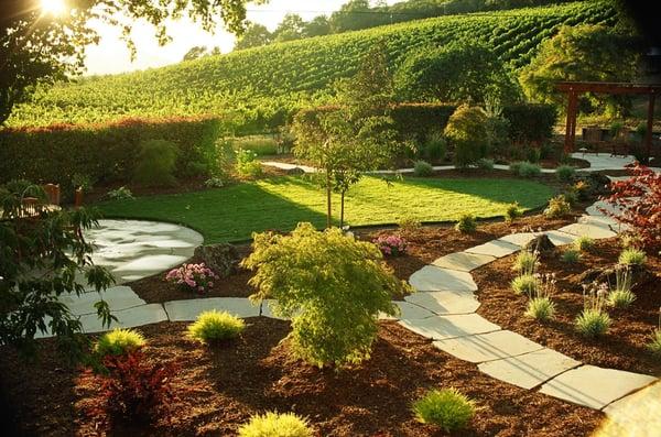 Flagstone pathways wind through a summer garden