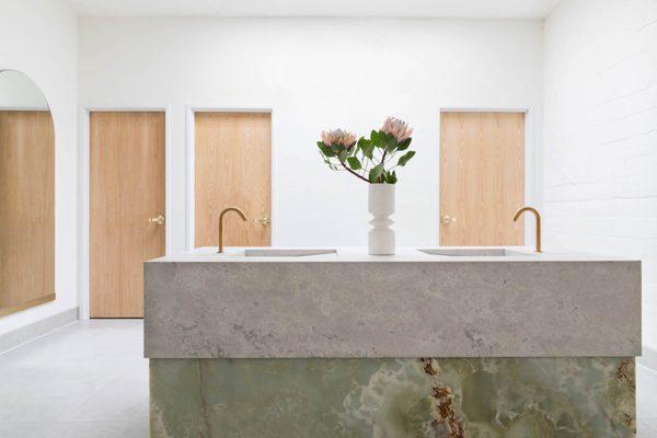 Adaptive Reuse Photostudio: Custom only and limestone vanity in the women's restroom