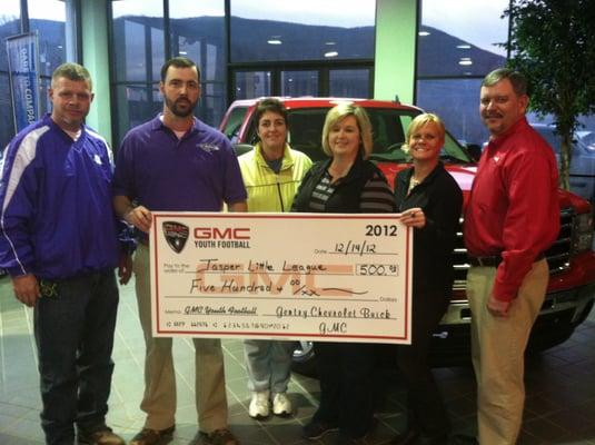 Mary Catherine Gentry, BDC- eCommerce Manager and Lee Belk, General Sales Manager present check to Jasper Little League from ...