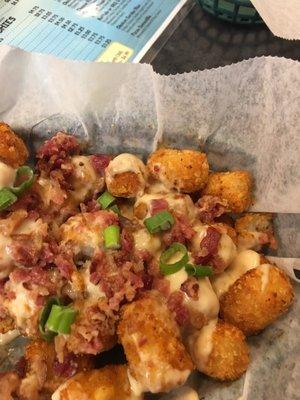 Try the tator tots with white cheddar and bacon. It's the bomb.com