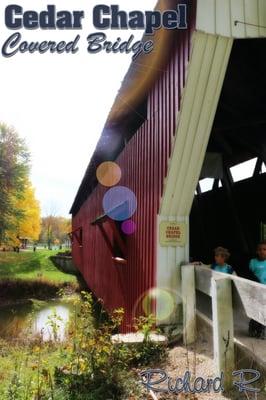 Typical of Indiana covered bridges, it has a white entrance face and barn red body.