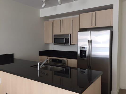 Axis on Brickell North Tower kitchen with Italian cabinetry, stainless steel appliances, and granite countertops.