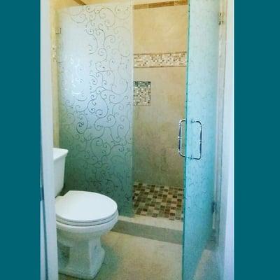 Custom frameless shower door. Custom sandblasted design. Installed in La Verne.