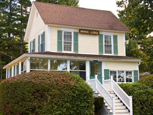 Smith Cove Chief Cottage Vacation Rental sleeps 6 features glass enclosed front porch with views of private beach, dock and the lake