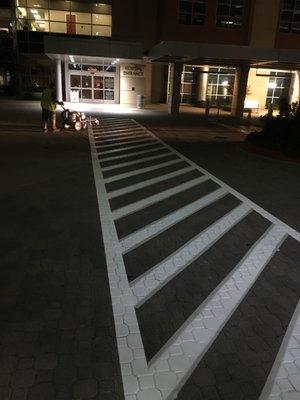 Striping a pedestrian crossing at a hospital