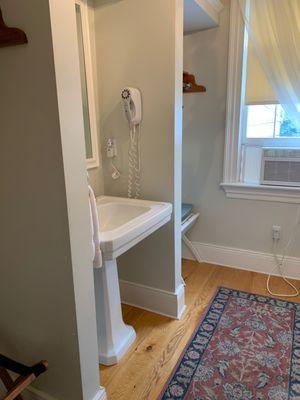 Galley room-luggage rack, sink, mirror, blow dryer, rack to hang clothes, iron & board, coffee maker & mini fridge, air conditioner.