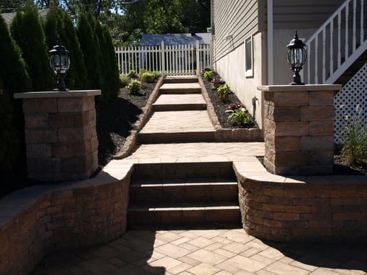 Light columns, staggered walkway, retaining walls, belguim block edging, and steps, and plantings