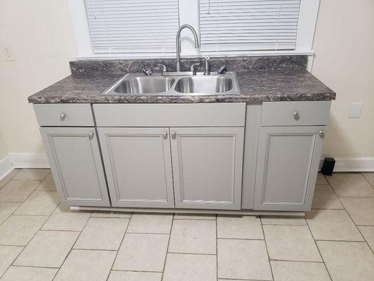 We installed new cabinets, counter tops and sink/faucet/plumbing