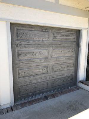 Wood tone garage door installed.