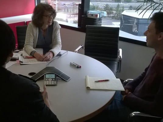 Meeting with three students in a conference room.