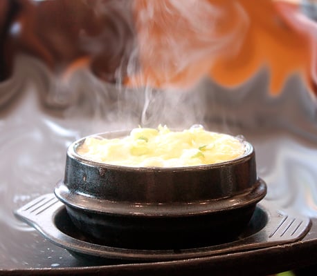 Steaming, bubbling egg and scallion souffle.