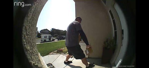 Mailman holding 2 packages