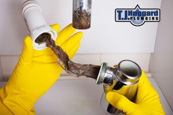 One of our plumbers fixing a clogged sink.