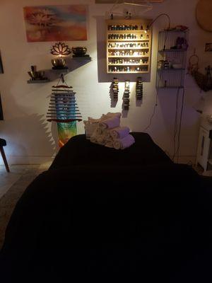 Treatment table, essential oils, towels and sound healing instruments all used for bodywork sessions