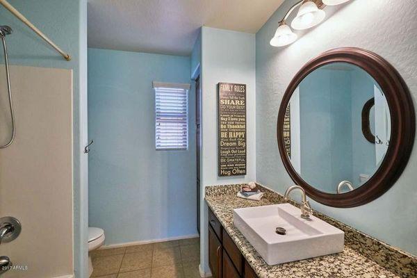 Remodeled Bath w/ granite countertop, upgraded sink, faucet, lighting, and mirror, along with custom paint.