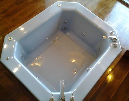 The blue color of this jetted tub made the bathroom very outdated.