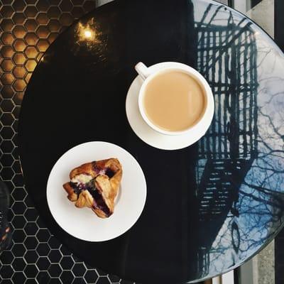 coffee and a blueberry cream cheese puff pastry.