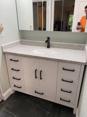 White granite bathroom vanity with custom backshelf