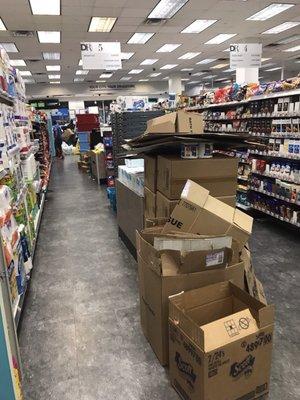 Piles of boxes and products not on shelves for customers to view.