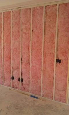 This is perfectly installed fiberglass insulation on an interior wall for sound control.