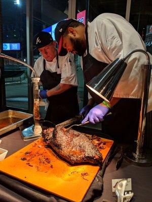 Oak-smoked brisket carving station. Company holiday party inside the Chop House.