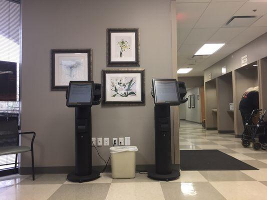 The checkin kiosks are around the corner from the door  (turn right when you walk in), but you can check in at the desk too.