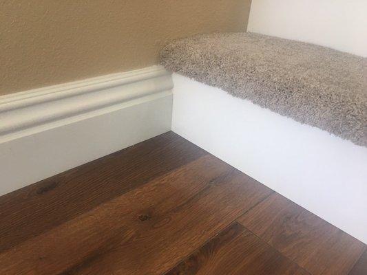 Cut and reinstalled baseboard at stair riser.