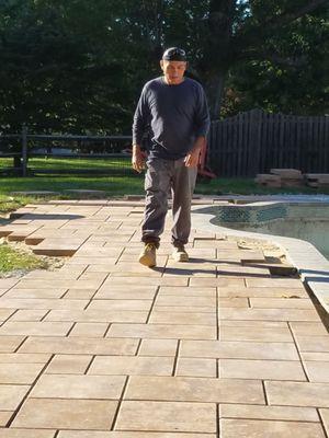 Owner of the company Mauricio laying pavers for pool project!