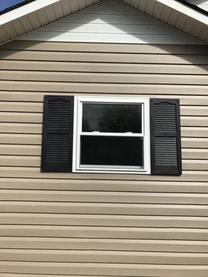 Vinyl siding and new  window with shutters