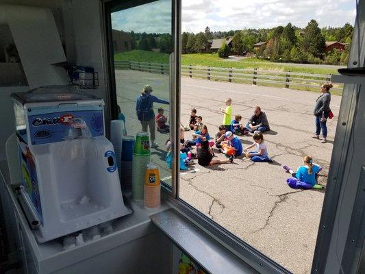 Enjoying some shaved ice at a before and after school program. Always a refreshing treat.