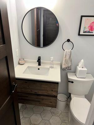 Replaced vanity, flooring, toilet. mirror, light and accessories.