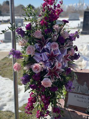 Standing spray pink flowers purple blossoms and green foliage