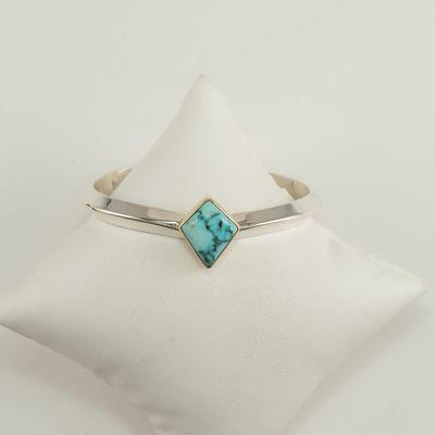 We have a new addition to our Turquoise collection! This cuff was made with Sterling Silver, a 14kt yellow gold bezel and Kingman turquoise.