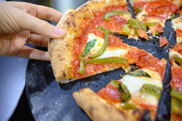 A delicious, handmade pie cooked in our Morello Forni oven. Try making your own at our pizza lab!