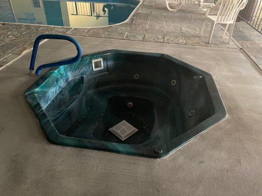 Empty hot tub, closed pool.