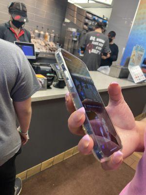 Workers on their phone while making the ice cream