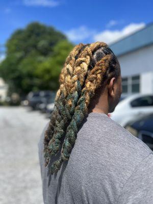 Braided locs mid back length.