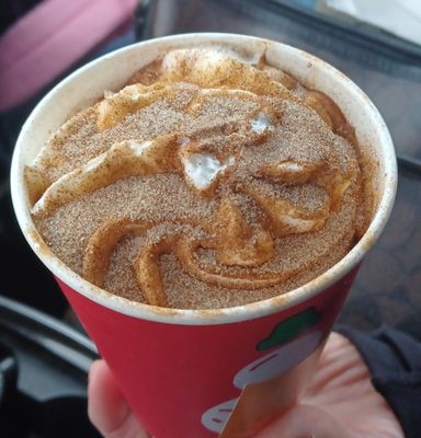 Caramel signature latte with whippes cream and cinnamon