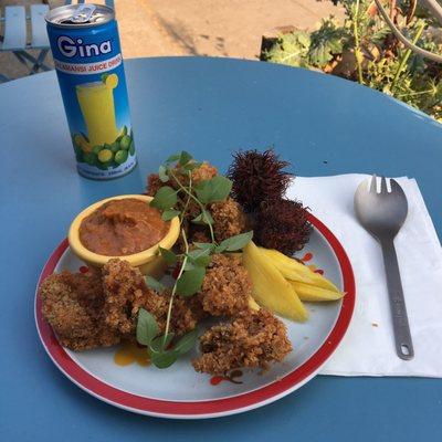 The pritong atay, complete with rambutan and picked mango, as well as a can of Filipino lime (kalamansi) juice.