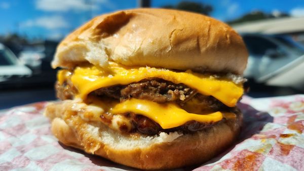 Delicious double cheeseburger with extra cheese request.