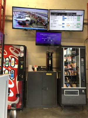 The beverage and snack area with the tv screens above it