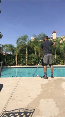 Yordan in process of doing a complete pool service and chemical balance.