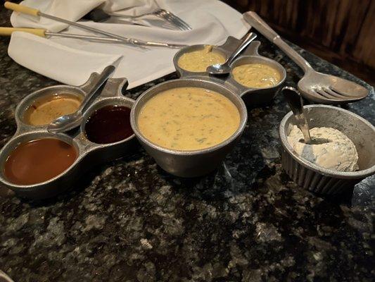 Dipping sauce trays, batter, and a dollop of cheese filling.