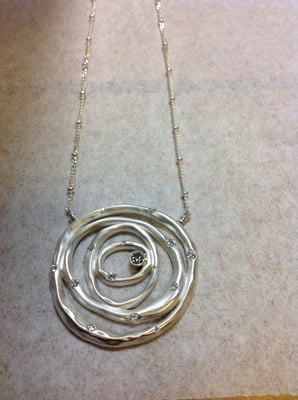 sterling silver nesting circle pendant set with customers diamonds.