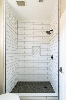 4x16 Subway with grey hexagon mosaic shower pan