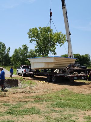 Crane lifting pool into place.