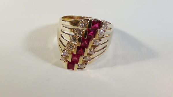 Size 8;  Weighs 6.6 grams
Red and clear cubic zircons
Little more than 3/4 inches tall and embedded with created ruby and z...