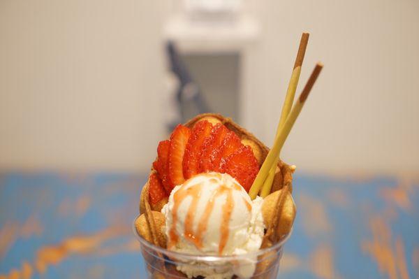 Hong King Egg Waffle. Vanilla Ice Cream. Strawberries. Strawberry syrup. Pocky.